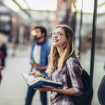 Happy university student going on a class at the university and